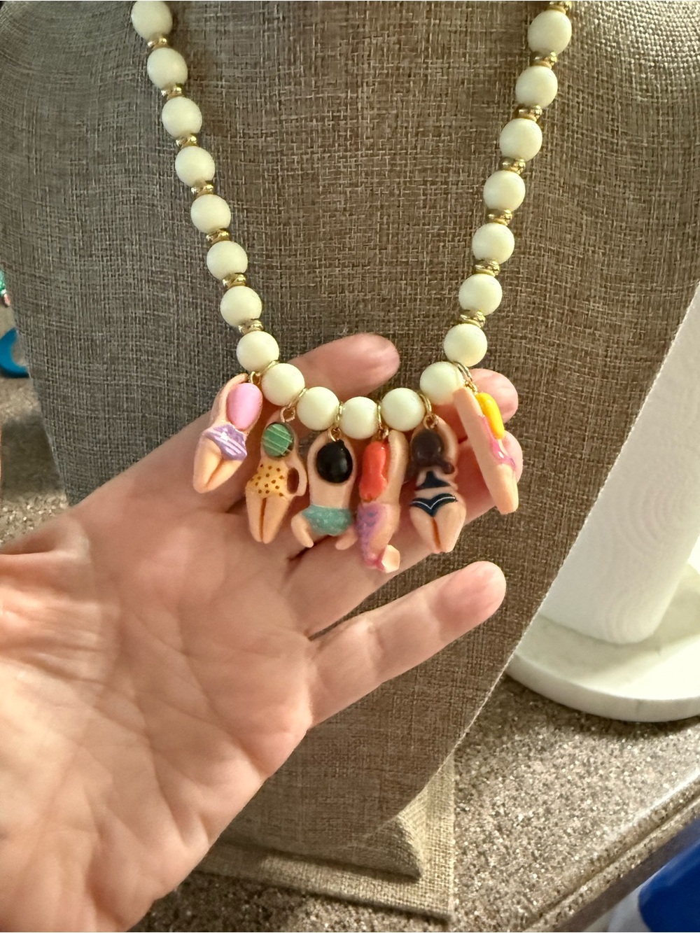White Beaded Necklace with Gold Accents and Multicolor Swimmer Charms - Picture 3 of 10